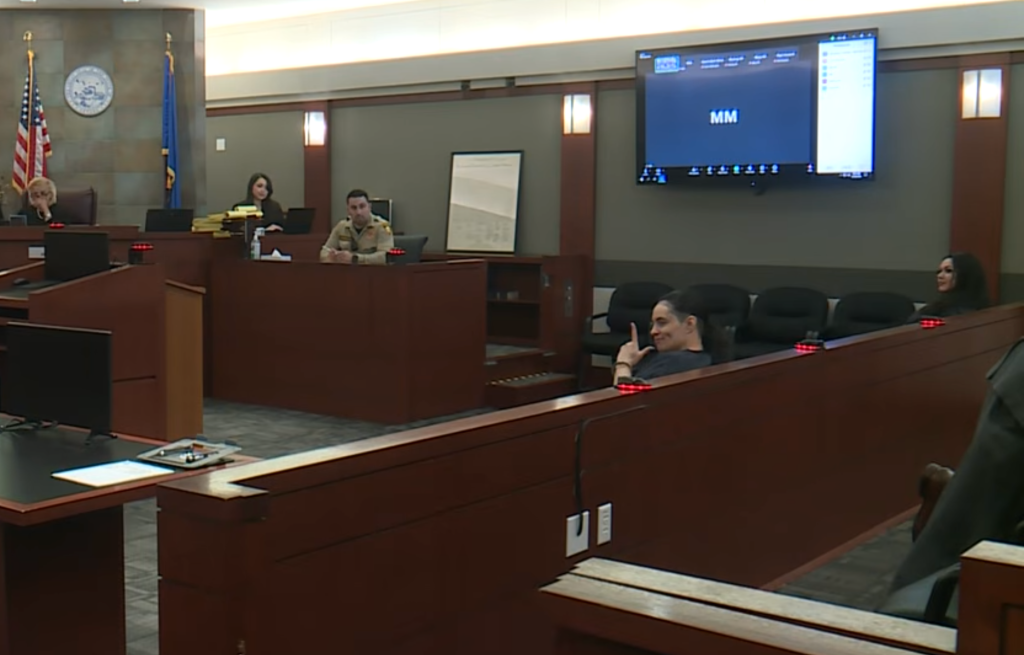 Alvarado gestures at cameras inside the courtroom before her sentencing.